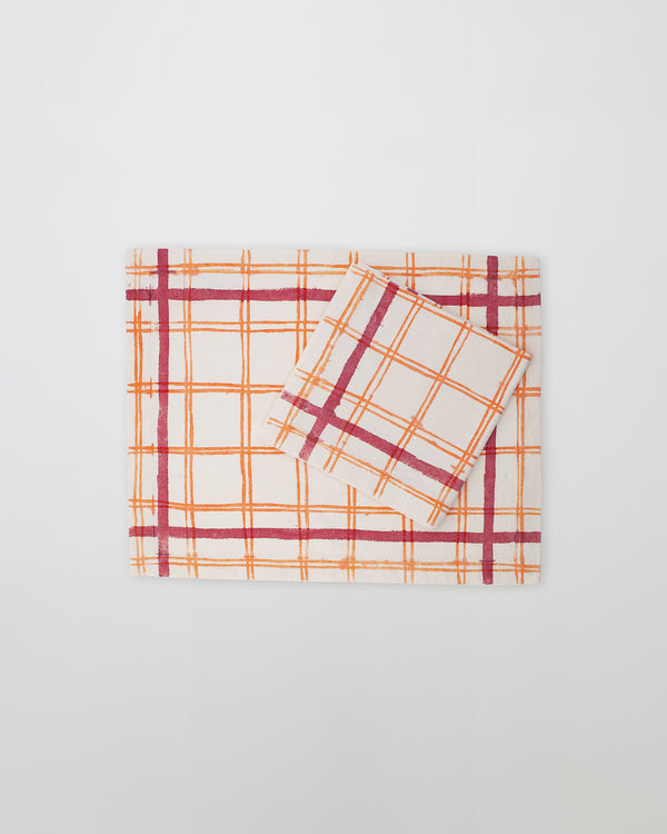 The placemat and the orange net napkin